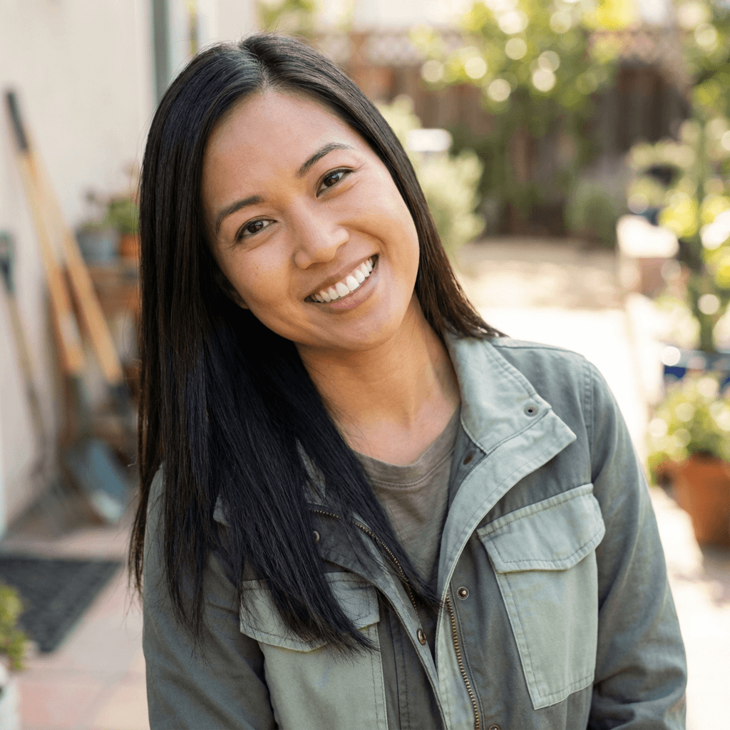 Rachel Kim in a cozy cardigan, standing near a finished interior wall